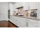 Stylish kitchen features modern appliances, white cabinets, and granite countertops at 12415 Es Draper Dr, Huntersville, NC 28078