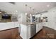 Spacious kitchen and living room combo featuring a large island with a stone fireplace at 12415 Es Draper Dr, Huntersville, NC 28078