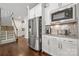 Kitchen area boasts stainless steel refrigerator, microwave, and granite countertops at 12415 Es Draper Dr, Huntersville, NC 28078