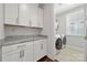 Well-equipped laundry room with ample cabinet space and a granite countertop at 12415 Es Draper Dr, Huntersville, NC 28078