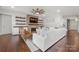 Cozy living room with a stone fireplace, built-in shelving, and a comfortable white sofa at 12415 Es Draper Dr, Huntersville, NC 28078