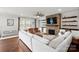 Inviting living room boasts a stone fireplace, built-in shelving, and hardwood floors at 12415 Es Draper Dr, Huntersville, NC 28078