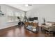 Well-lit office space with hardwood floors, large windows, modern desk, and comfortable seating area at 12415 Es Draper Dr, Huntersville, NC 28078