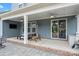 Covered outdoor patio featuring a seating area, heater, television, and brick flooring for outdoor relaxation at 12415 Es Draper Dr, Huntersville, NC 28078