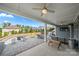 Relaxing outdoor patio with a fire pit, seating, grill, dining table, and ceiling fans for comfort at 12415 Es Draper Dr, Huntersville, NC 28078