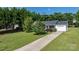 A beautiful bird's eye view of a house with a large grassy yard and tall trees at 1265 39Th Street Cir, Hickory, NC 28602