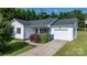 Charming single-Gathering home with white siding, black shutters, and a well-manicured lawn and a driveway at 1265 39Th Street Cir, Hickory, NC 28602