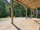 The back patio's wood supports offer a place to relax and enjoy the natural beauty at 14019 Fountain Ln, Charlotte, NC 28278