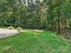 The backyard features a lush lawn, stone path, and firepit area at 14019 Fountain Ln, Charlotte, NC 28278
