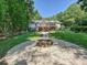 A wide shot of the home, showing the firepit in the backyard with screened in porch at 14019 Fountain Ln, Charlotte, NC 28278