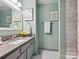 Clean bathroom with updated vanity, framed mirrors, and tiled shower at 14019 Fountain Ln, Charlotte, NC 28278