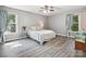 Cozy bedroom with two windows, wood-look floors, and light blue accents at 14019 Fountain Ln, Charlotte, NC 28278