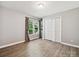 Bedroom with wood-look flooring, storage closet, and window with backyard view at 14019 Fountain Ln, Charlotte, NC 28278