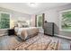 Bright bedroom with hardwood floors, area rug, and plenty of natural light at 14019 Fountain Ln, Charlotte, NC 28278