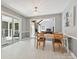 Dining area offering a view to a cozy living room and access to the outdoor deck at 14019 Fountain Ln, Charlotte, NC 28278
