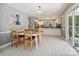 Dining area features a chandelier and views into the kitchen with white cabinets at 14019 Fountain Ln, Charlotte, NC 28278