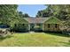 Charming single-story home with stone accents, green siding, and a well-manicured lawn at 14019 Fountain Ln, Charlotte, NC 28278