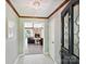 Elegant foyer featuring tile flooring, a chandelier, and views into the living room at 14019 Fountain Ln, Charlotte, NC 28278