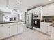Kitchen boasts white cabinets, stainless steel appliances, and an island with bar seating at 14019 Fountain Ln, Charlotte, NC 28278