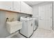 Laundry room featuring a sink, overhead cabinets, and a washer and dryer at 14019 Fountain Ln, Charlotte, NC 28278