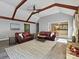 Spacious living room featuring vaulted ceilings with wooden beams, grey walls, and a fireplace at 14019 Fountain Ln, Charlotte, NC 28278