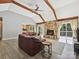 Spacious living room with vaulted ceilings, a stone fireplace, and access to the outdoor deck at 14019 Fountain Ln, Charlotte, NC 28278