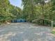 View of the colorful outbuilding and metal carport, offering ample storage at 14019 Fountain Ln, Charlotte, NC 28278