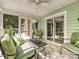 Relaxing screened porch with tiled floor, ceiling fan, and comfortable seating at 14019 Fountain Ln, Charlotte, NC 28278