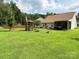 Expansive backyard featuring lush green grass, a gazebo, and an American flag at 1412 Cold Creek Pl, Huntersville, NC 28078