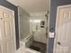 Modern bathroom featuring a glass-enclosed shower with new tile and bench seating at 1412 Cold Creek Pl, Huntersville, NC 28078