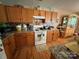 Functional kitchen with oak cabinets, laminate countertops, and white appliances at 1412 Cold Creek Pl, Huntersville, NC 28078