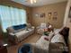 Comfortable living room with floral patterned furniture and Carolina Panthers memorabilia at 1412 Cold Creek Pl, Huntersville, NC 28078