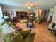 Cozy living room with hardwood floors, ceiling fan, and comfortable seating at 1412 Cold Creek Pl, Huntersville, NC 28078