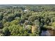 Aerial view of the property surrounded by trees and a lake at 143 Bostian Lake Rd, Statesville, NC 28677