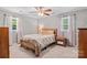 Bright bedroom featuring a ceiling fan, hardwood furniture and natural light from the windows at 143 Bostian Lake Rd, Statesville, NC 28677