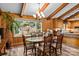 Inviting dining room with wood paneled walls, beamed ceiling, ample natural light, and view of the outdoors at 143 Bostian Lake Rd, Statesville, NC 28677