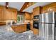 Well-appointed kitchen with stainless steel appliances, oak cabinets, and a countertop with breakfast bar seating at 143 Bostian Lake Rd, Statesville, NC 28677