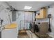 Bright laundry room area featuring washer, dryer and shelving unit at 143 Bostian Lake Rd, Statesville, NC 28677