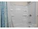 Shower featuring a tile surround and built in shelves at 143 Bostian Lake Rd, Statesville, NC 28677
