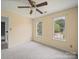 Cozy bedroom with carpet flooring, ceiling fan and two windows at 14520 Cardamon Ct, Charlotte, NC 28273