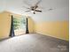 Bright bedroom with carpet, ceiling fan, sloped ceiling and one window at 14520 Cardamon Ct, Charlotte, NC 28273