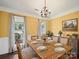 Dining room with a wooden table and an elegant chandelier at 14520 Cardamon Ct, Charlotte, NC 28273