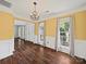 Bright dining room featuring wood floors, wainscoting, and natural light at 14520 Cardamon Ct, Charlotte, NC 28273