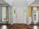 Inviting foyer featuring wood floors, a white front door, and windows for natural light at 14520 Cardamon Ct, Charlotte, NC 28273