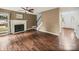 Spacious living room featuring a fireplace, ceiling fan and dark hardwood floors at 14520 Cardamon Ct, Charlotte, NC 28273