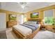 Spacious main bedroom suite with tray ceiling, a ceiling fan, natural light, and wood furniture at 14520 Cardamon Ct, Charlotte, NC 28273
