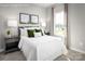 Comfortable bedroom showcases a gray headboard, two side tables and bedside lamps, and green accent pillows at 1474 Samuel St, Charlotte, NC 28206
