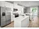 Modern kitchen featuring white cabinets, stainless steel appliances, and light countertops at 1474 Samuel St, Charlotte, NC 28206