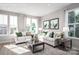 Bright living room with two sofas, large windows, and a stylish coffee table at 1474 Samuel St, Charlotte, NC 28206