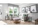 Inviting living room with a large window, gray sectional sofa, accent pillows, and light wood flooring at 1474 Samuel St, Charlotte, NC 28206